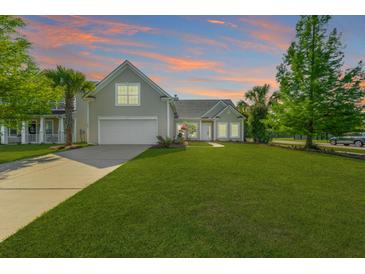 Charming home with a well-manicured lawn, beautiful landscaping, and a two-car garage at 7601 Stargazer Dr, Hanahan, SC 29410