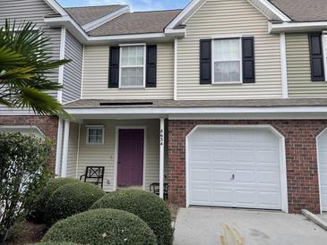 Charming townhome featuring a purple front door and a one car garage at 8634 Grassy Oak Trl, North Charleston, SC 29420