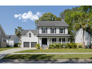 Charming two-story home with a welcoming front porch, lush lawn, and manicured landscaping at 193 Corn Planters St, Charleston, SC 29492