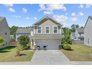 Charming two-story home with a well-manicured lawn and a two-car garage at 409 Thoroughbred Dr, Moncks Corner, SC 29461