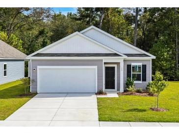 Charming single-story home featuring a two-car garage, manicured lawn, and inviting front entrance at 544 Pender Woods Dr, Summerville, SC 29486