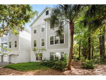 Charming three-story home with gray siding, white trim, and lush landscaping, nestled among mature trees and a palm tree at 60 Fenwick Hall Allee # 321, Johns Island, SC 29455