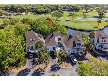 Beautiful elevated angle of the condo showing landscaping, updated roof, and stunning golf course and water views at 732 Spinnaker Beachhouse, Seabrook Island, SC 29455