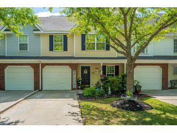 Inviting townhome featuring a well-manicured front yard and welcoming entryway at 8652 Grassy Oak Trl, North Charleston, SC 29420