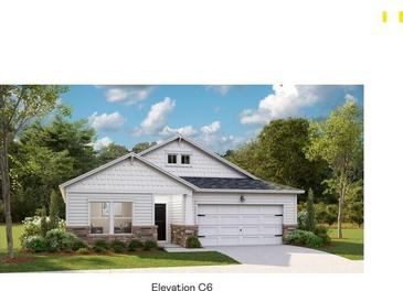 Charming single-story home showcasing a welcoming two-car garage and manicured front yard at 1033 Sagegrass St, Summerville, SC 29485