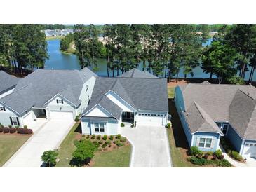 Aerial view of charming blue home with a well-manicured lawn and stunning water views at 108 Bluff Isle Ct, Summerville, SC 29486
