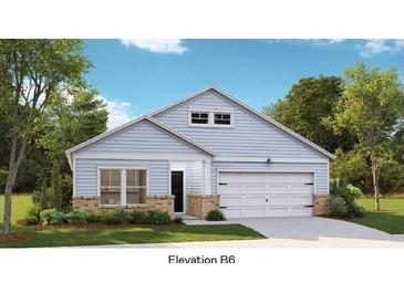 Charming one-story home featuring light blue siding, brick accents, and a two-car garage at 1149 Darling St, Summerville, SC 29485