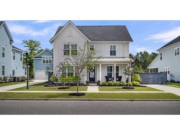 Charming two-story home with a well-manicured front yard and inviting porch at 116 Backhurst Dr, Summerville, SC 29486
