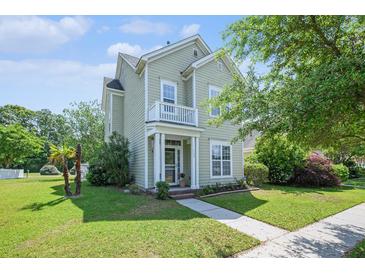 Charming two-story home featuring a quaint balcony, manicured lawn, and inviting front entrance at 117 Blue Bonnet St, Summerville, SC 29483