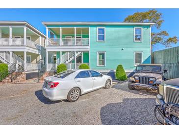 Charming two-story home with a gravel driveway and a light blue exterior at 172 Saint Philip St # F, Charleston, SC 29403