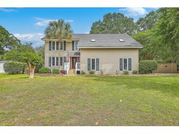 Two-story home with a well-manicured lawn and palm tree at 2275 Pristine View Rd, Charleston, SC 29414