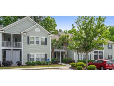 Exterior of a lovely condo building, with well-maintained landscaping and ample parking at 308 Pickering Ln, Charleston, SC 29414