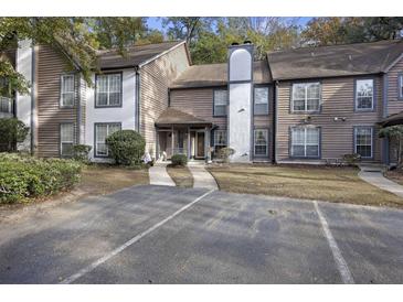 Inviting townhome with covered entrance, chimney, and dedicated parking at 7935 Edgebrook Cir # 2202, North Charleston, SC 29418