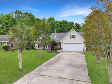 Charming home with a manicured lawn and a long drive, creating a welcoming approach at 1061 Reverend Joseph Heyward Rd, Charleston, SC 29414