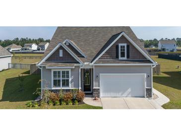 Charming single-Gathering home featuring a two-car garage and neutral siding at 312 Cypress Branch Rd, Huger, SC 29450