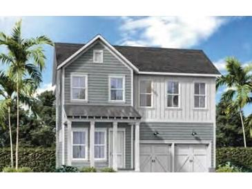 Charming two-story home featuring gray siding, white trim, and a two-car garage in a lush, tropical setting at 360 Trailmore Ln, Summerville, SC 29486