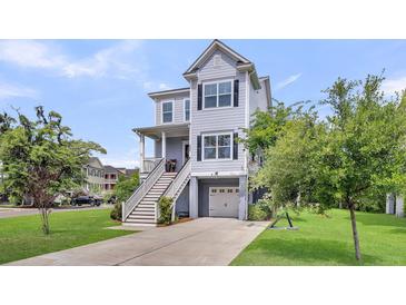 Charming coastal home with a garage, elevated living space, and a well-maintained front yard at 482 Sanders Farm Ln, Wando, SC 29492