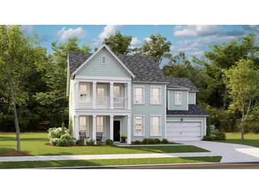 Charming two-story home with a welcoming front porch and attached garage, nestled among lush trees at 549 Richfield Way Way, Summerville, SC 29486