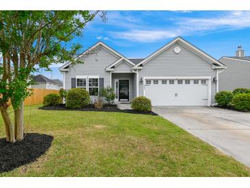 Charming single-story home with a well-maintained lawn, manicured landscaping, and an attached two-car garage at 1007 Halfacre Ln, Ladson, SC 29456