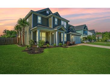Inviting two-story home with a lush green lawn, well-manicured landscaping, and a welcoming front porch at 101 Firebrick Way, Summerville, SC 29483
