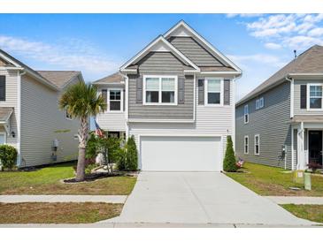 Charming two-story home featuring a grey shingled roof, attached two-car garage, and a well-manicured front lawn at 1052 Sago Palm Ct, Mount Pleasant, SC 29429