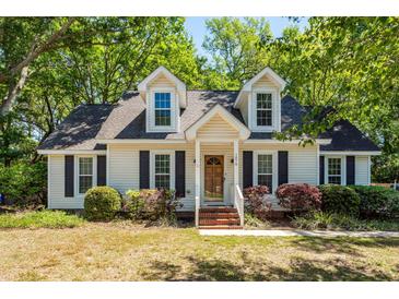 Charming home featuring dormer windows, a brick walkway, and mature landscaping at 1070 Blue Marlin Dr, Charleston, SC 29412