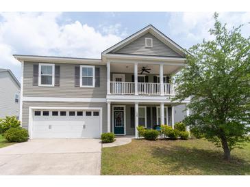 Charming two-story home with a welcoming front porch and a well-maintained lawn at 138 Shadybrook Dr, Summerville, SC 29486