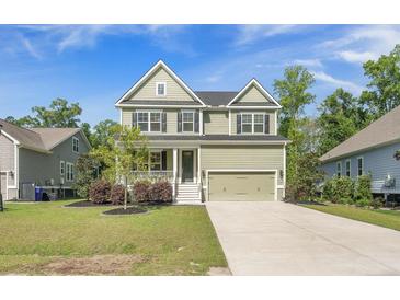Charming two-story home features a covered front porch and a two-car garage at 1489 Brockenfelt Dr, Charleston, SC 29414