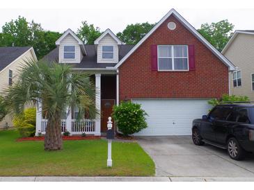 Charming two-story brick home with a well-manicured lawn and a palm tree in the front yard at 1757 Wayah Dr, Charleston, SC 29414