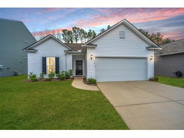 Charming single-story home with a well-manicured lawn and attached two-car garage at 224 Hayworth Rd, Summerville, SC 29486
