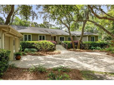 Charming single-story home featuring manicured landscaping and a spacious driveway at 2355 Andell Way, Seabrook Island, SC 29455