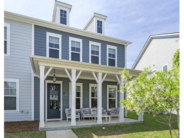 Charming two-story home with a welcoming front porch and manicured lawn at 3130 Sturbridge Rd, Mount Pleasant, SC 29466