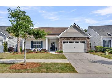 Charming single-Gathering home with stone accents, a well-maintained lawn, and a two-car garage at 440 Four Seasons Blvd, Summerville, SC 29486
