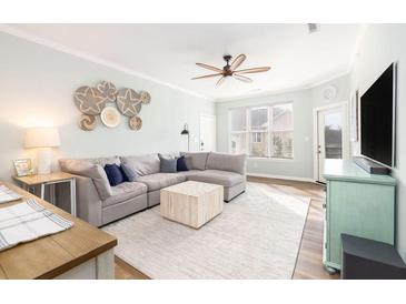 Bright living room with a large sectional couch, stylish decor, and a ceiling fan at 600 Bucksley Ln # 305, Charleston, SC 29492