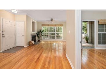 Bright living room boasts hardwood floors, fireplace, large window, and neutral paint at 700 Daniel Ellis Dr # 4104, Charleston, SC 29412
