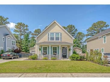 Charming two-story home featuring a well-manicured lawn and a welcoming front porch, exuding curb appeal in a serene neighborhood at 7414 Purser Ln, Hanahan, SC 29410