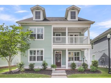 Charming two-story home featuring a double porch, well-maintained landscaping, and a welcoming entrance at 81 Crossandra Ave, Summerville, SC 29483