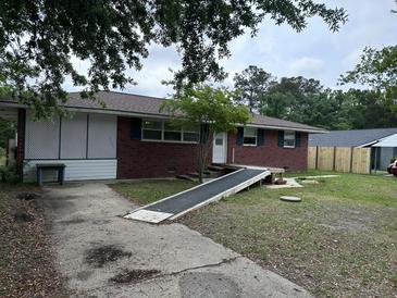 Charming single-story brick house with a ramp leading to the front door at 10 Cranford Rd, Goose Creek, SC 29445