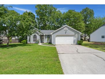 Charming single Gathering home with a lush lawn, mature trees, and a two-car garage at 102 Amberside Dr, Goose Creek, SC 29445