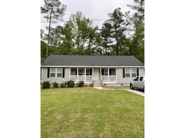 Charming ranch-style home with a well-maintained front lawn and inviting curb appeal at 110 Kay St, Ridgeville, SC 29472
