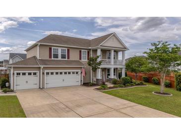 Charming two-story home with a three-car garage and manicured lawn at 110 Ricewood Ln, Moncks Corner, SC 29461