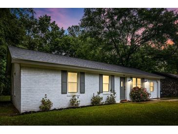 Charming white brick home features a well-maintained lawn and inviting curb appeal at 120 Lisa Dr, Summerville, SC 29485