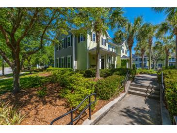 Inviting two-story home with well-maintained landscaping and mature palm trees, enhancing curb appeal at 1225 Blakeway St # 1401, Charleston, SC 29492