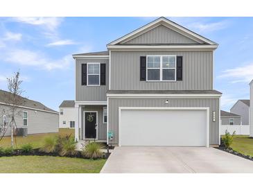 Charming two-story home with a two-car garage, landscaped yard, and grey siding with black shutters at 244 Wild Strawberry Ln, Moncks Corner, SC 29461