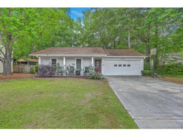 Charming one-story home with well-manicured lawn and attached garage in a serene setting at 3230 Landing Pkwy, North Charleston, SC 29420