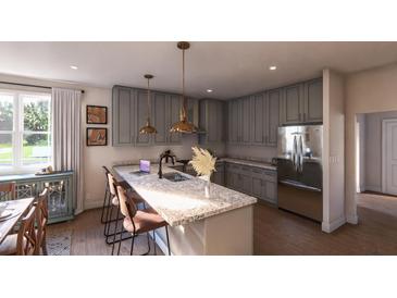 Modern kitchen with stainless steel appliances, pendant lighting, and a large center island with bar seating at 401 Oak Hammock Ct # 48, Johns Island, SC 29455
