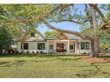 Beautiful craftsman home featuring a landscaped front yard, white siding, and a welcoming entryway at 422 Palm St, Mount Pleasant, SC 29464