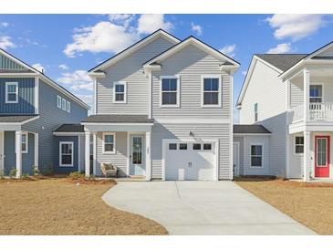 Charming two-story home with gray siding, a white garage door, and well-manicured front yard at 488 Queenview Ln, Charleston, SC 29414