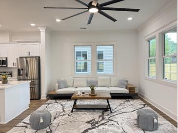 Bright living room featuring modern decor, a stylish area rug, and comfortable seating at 5841 Kirkwood Ave, North Charleston, SC 29406
