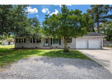 Charming brick home with a well-maintained yard and a two-car garage on a sunny day at 115 Myers Rd, Summerville, SC 29486